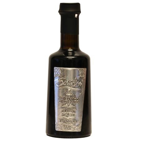 Dark glass bottle with silver label on a white background