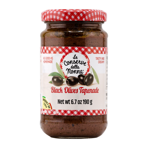 Jar of Black Olives Tapenade with a red and white checkered lid on a white background