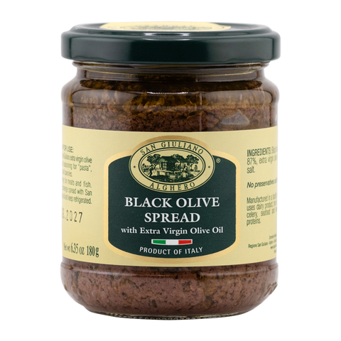 Jar of black olive spread with a label on a white background