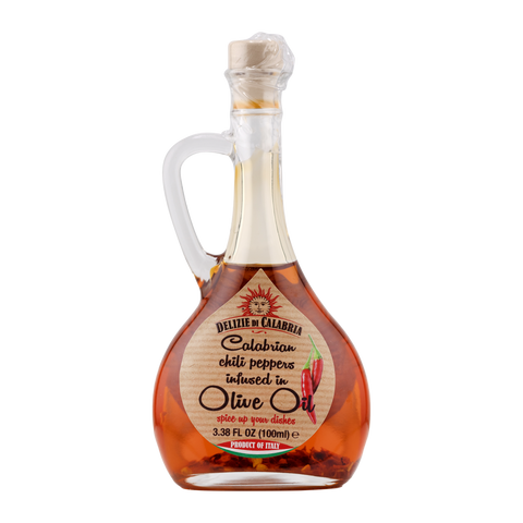 Bottle of Calabrian chili peppers infused in olive oil on a white background