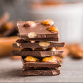 Stack of chocolate bars with nuts on a blurred background