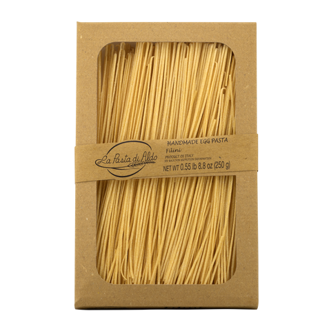 Box of La Pasta di Aldo pasta with clear window showing spaghetti inside on a white background