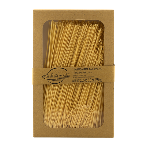 Box of handmade egg pasta with a clear window on a white background