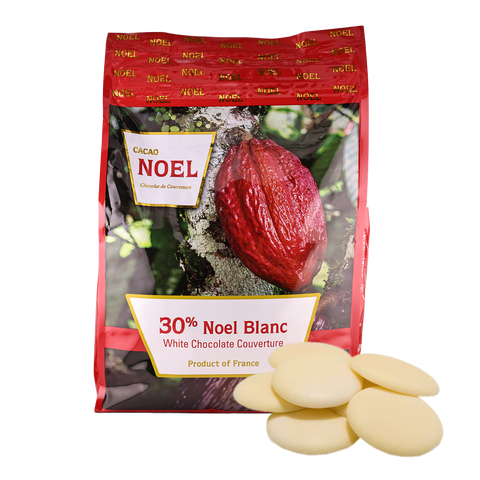 Cacao Noel packaging with white chocolate pieces on a white background