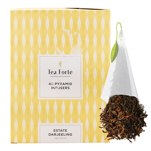 Tea Forte pyramid infusers packaging with a white infuser and tea leaves on a yellow patterned background.