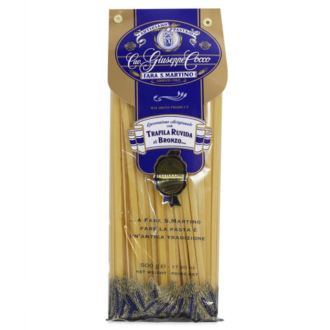 Packaged pasta with a blue and gold label on a white background