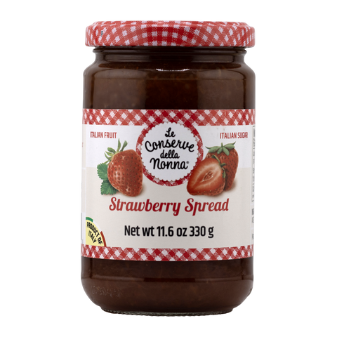 Jar of strawberry spread with a red and white checkered lid on a white background
