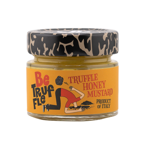 Jar of truffle honey mustard with a decorative label on a white background