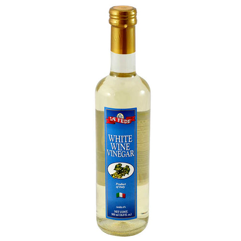 Bottle of white wine vinegar with a blue label on a white background